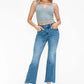 Young woman wearing bytos Raw Hem Distressed Mid Rise Crop Jeans with a trendy gray crop top and stylish clear heels.