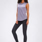 Stylish model wearing Millennia wide seamless band waist sports leggings with a lilac top and white sneakers.