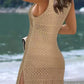 Woman in camel openwork scoop neck cover up by the beach, showcasing its playful design and slit details.