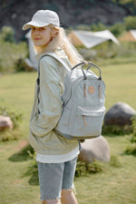 Person wearing a Himawari waterproof backpack with multilayer pockets, ideal for outdoor adventures and everyday use.