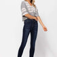 Woman wearing High Waist Handsand Skinny Judy Blue Jeans with a striped top and sandals