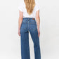 Woman wearing Judy Blue full-size high-rise double button wide leg jeans, showcasing stylish back view design and pocket details.