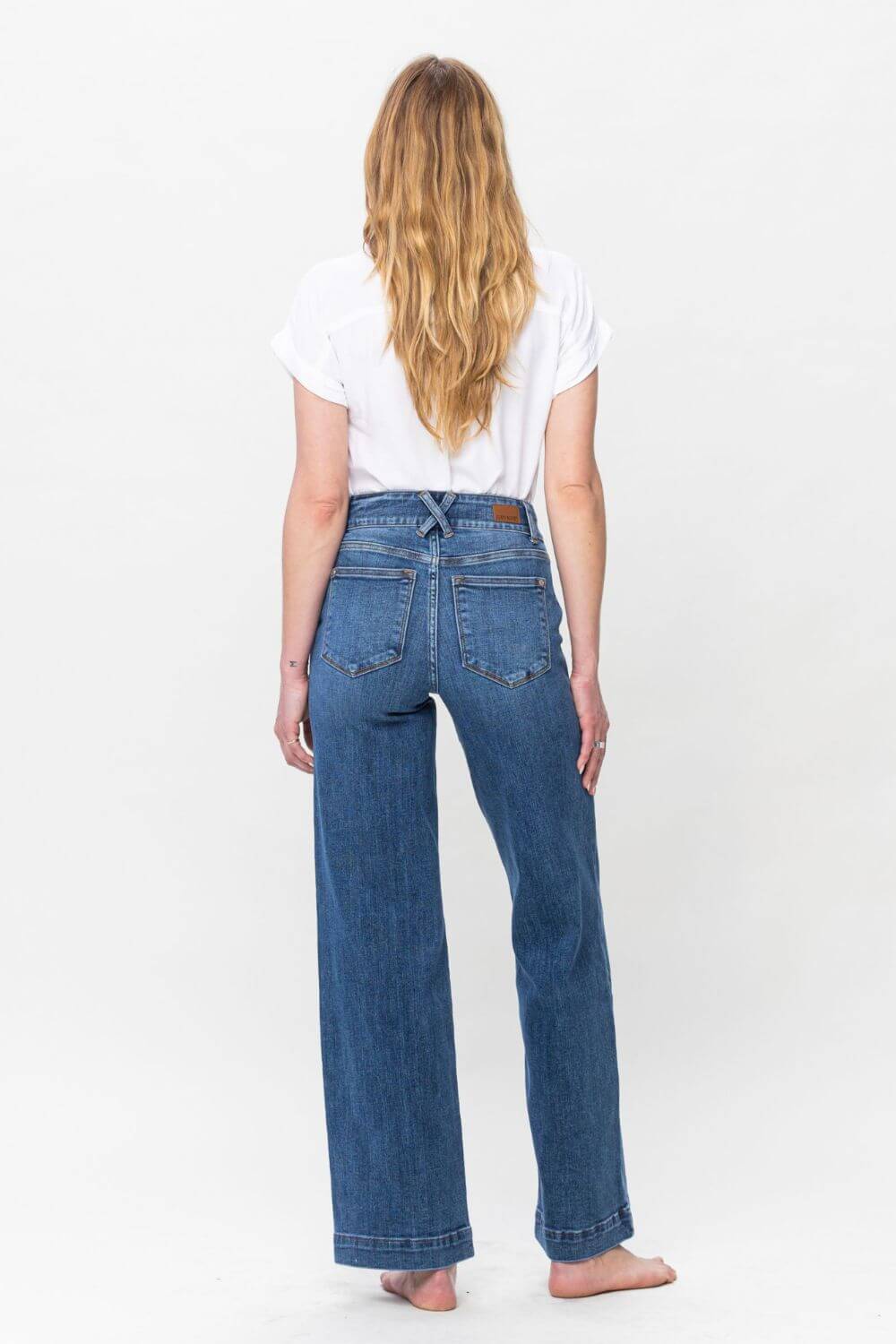 Woman wearing Judy Blue full-size high-rise double button wide leg jeans, showcasing stylish back view design and pocket details.