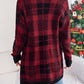 Woman wearing Bella Road Plaid Open Front Long Sleeve Cardigan in red and black standing by a Christmas tree.