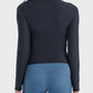 Back view of the Millennia Round Neck Long Sleeve Sports Top paired with stylish blue leggings for a sporty look.