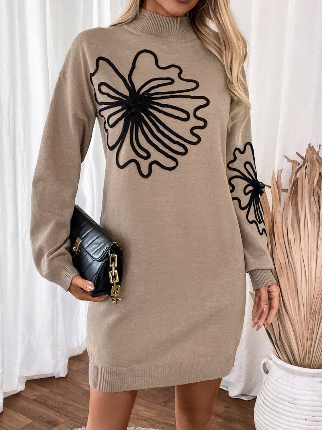 Woman wearing Perfee Flower Mock Neck Long Sleeve Sweater Dress holding a black clutch