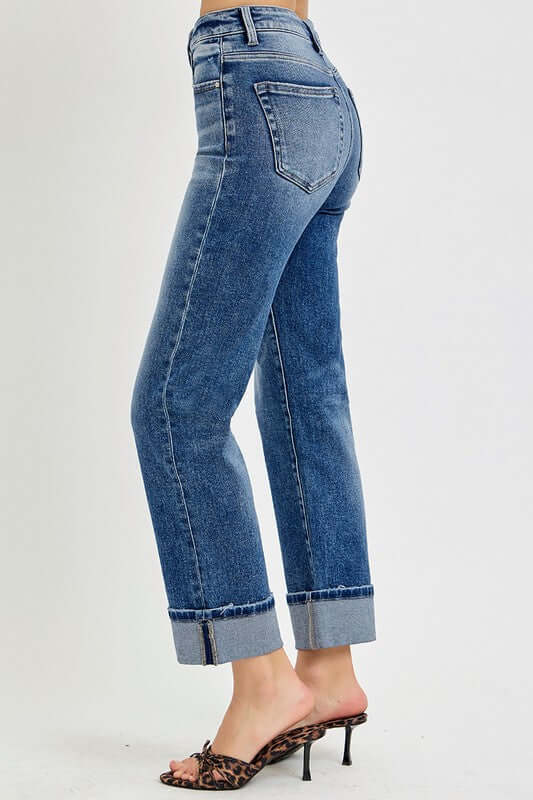 Woman wearing RISEN Full Size High Rise Crop Straight Roll Up Jeans, showcasing a stylish rolled hem and flattering fit.