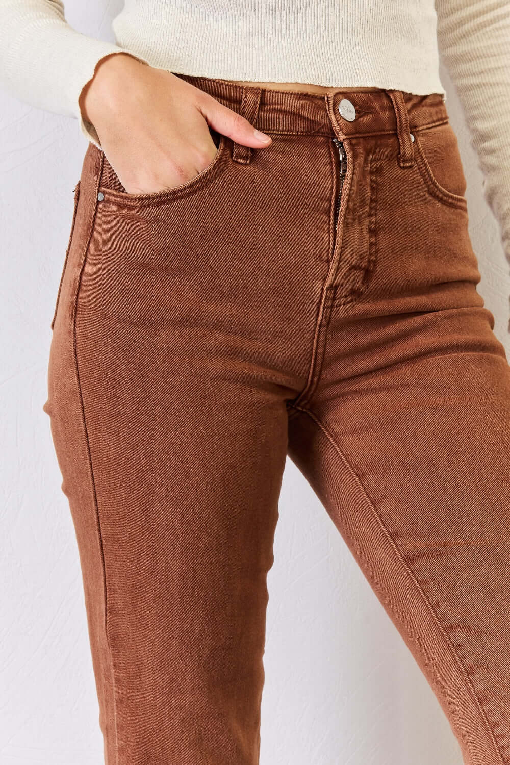 Close-up of High Rise Tummy Control Straight Jeans with raw hem and pocket, featuring Risen Jeans' flattering fit and no-stretch cotton blend.