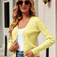 Woman wearing Bella Road Button Up Long Sleeve Cardigan in yellow, styled with sunglasses, white top, and jeans, showcasing a chic and cozy look.