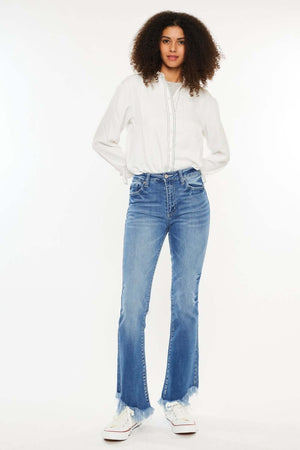 Woman wearing Kancan High Rise Frayed Hem Jeans with a white shirt, showcasing a trendy medium stone wash denim look.