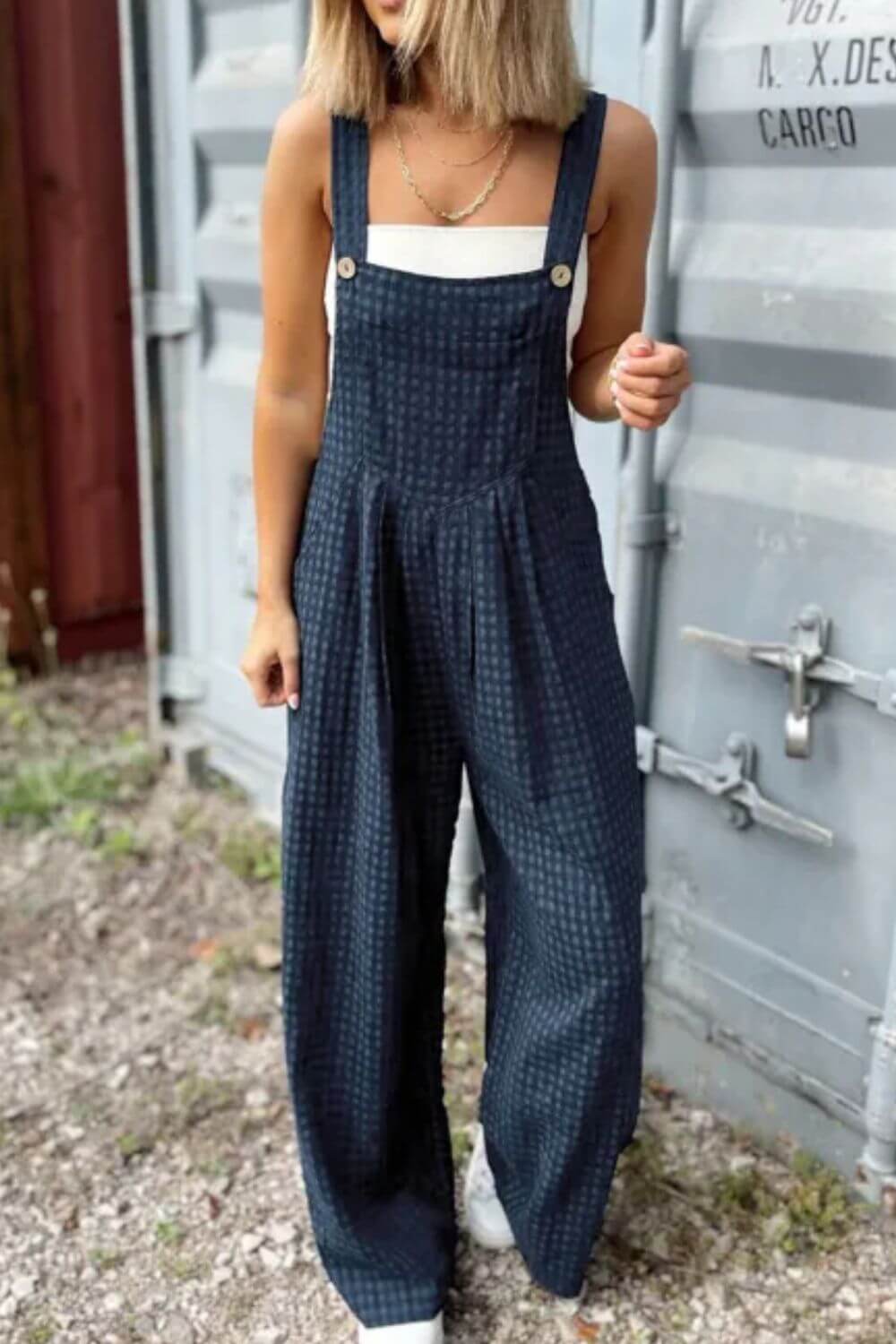 Woman wearing Bella Road plaid wide strap, wide leg overalls, perfect for stylish adventures.