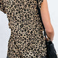 Bella Road leopard print ruffled T-shirt with cap sleeves, round neck, worn with black shorts and a bag, showcasing playful style.