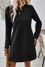 Bella Road textured long sleeve mini dress in black, featuring a round neck and stylish design for any occasion.