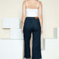 Woman wearing Judy Blue side seam braid detail crop wide leg jeans, showcasing the back view and stylish braided design.