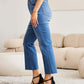 Woman wearing Mini Mia Full Size Tummy Control High Waist Jeans by RFM Jeans, showcasing the flattering high waist and slimming fit.