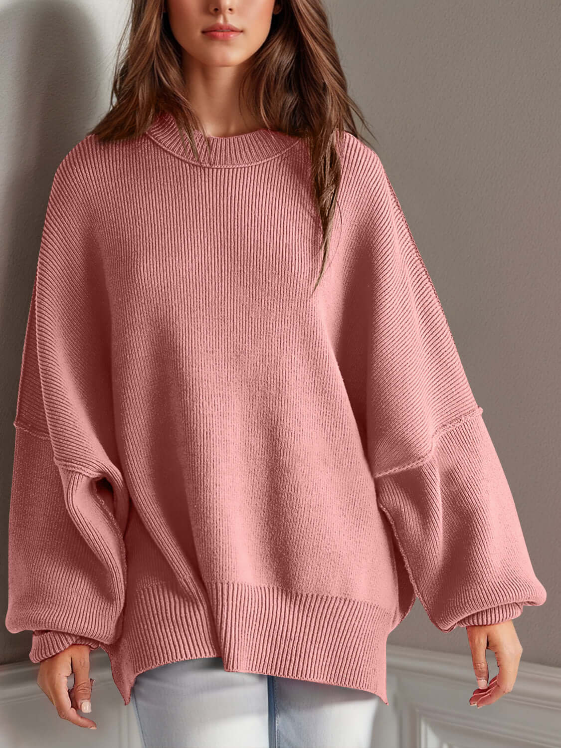 Woman wearing a cozy pink Double Take Side Slit Round Neck Long Sleeve Sweater with moderate stretch, made from 95% cotton and 5% polyester.