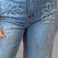 Close-up of Rhinestone Straight Jeans with flower patterns and pockets, made from cotton-polyester blend, showcasing stylish embellishments.