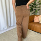 Woman wearing RFM Full Size High Rise Garment Dye Wide Leg Jeans in brown, showcasing back and relaxed fit, paired with black top.