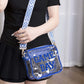 Woman holding Zenana GAME DAY clear crossbody bag with glittered trim and blue adjustable strap. Perfect for stadium events.