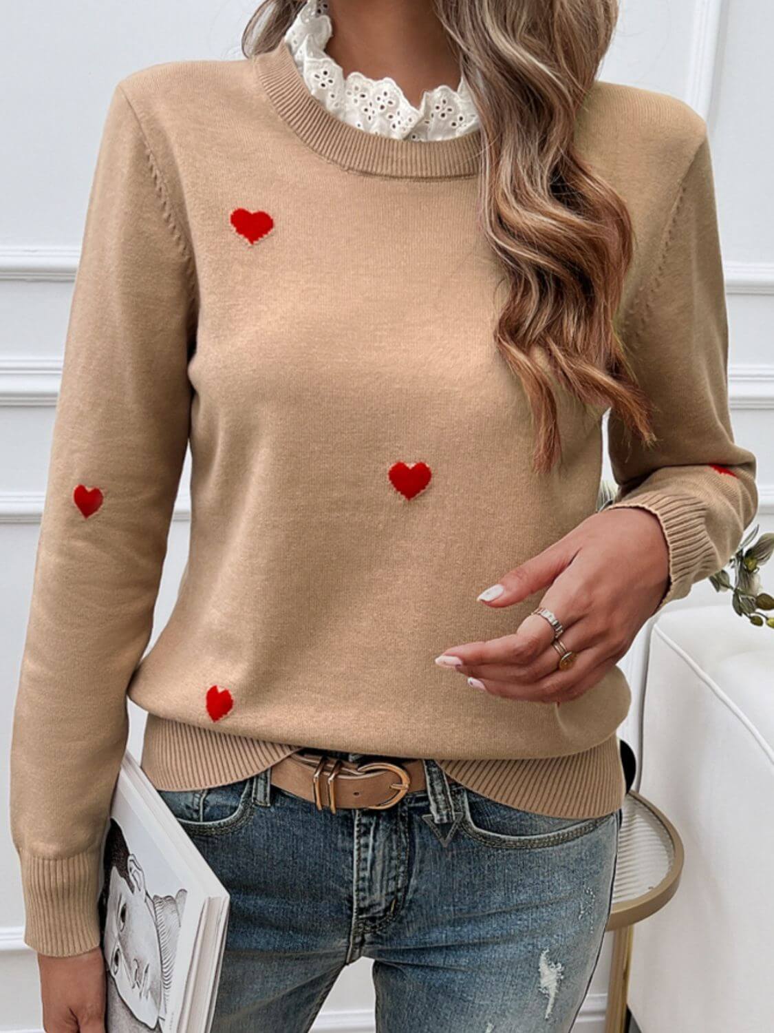 Woman wearing Devine Lace Detail Heart Long Sleeve Sweater in beige with red heart details, paired with jeans.