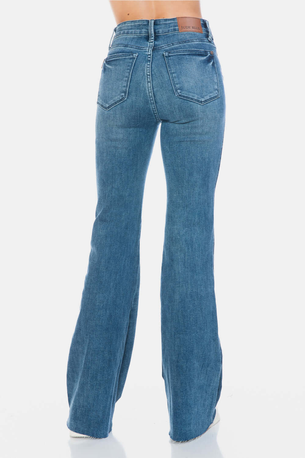 Judy Blue Full Size Tummy Control Cut Hem Flare Jeans back view in vintage wash, showcasing stylish cut hem and flattering silhouette.