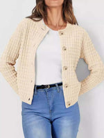 Woman wearing Bella Road Button Up Round Neck Long Sleeve Cardigan in beige over a white top with blue jeans.