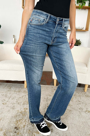 Woman wearing Mid Rise Release Hem Judy Blue Jeans in a living room setting