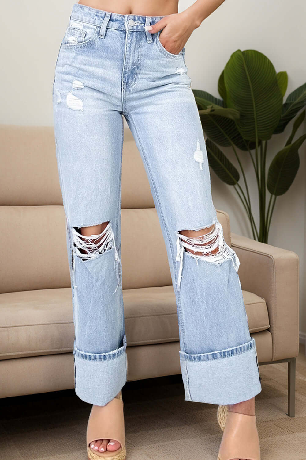 Stylish distressed high waist jeans with pockets, slightly stretchy for comfort, featuring a trendy ripped design, perfect for casual chic looks.