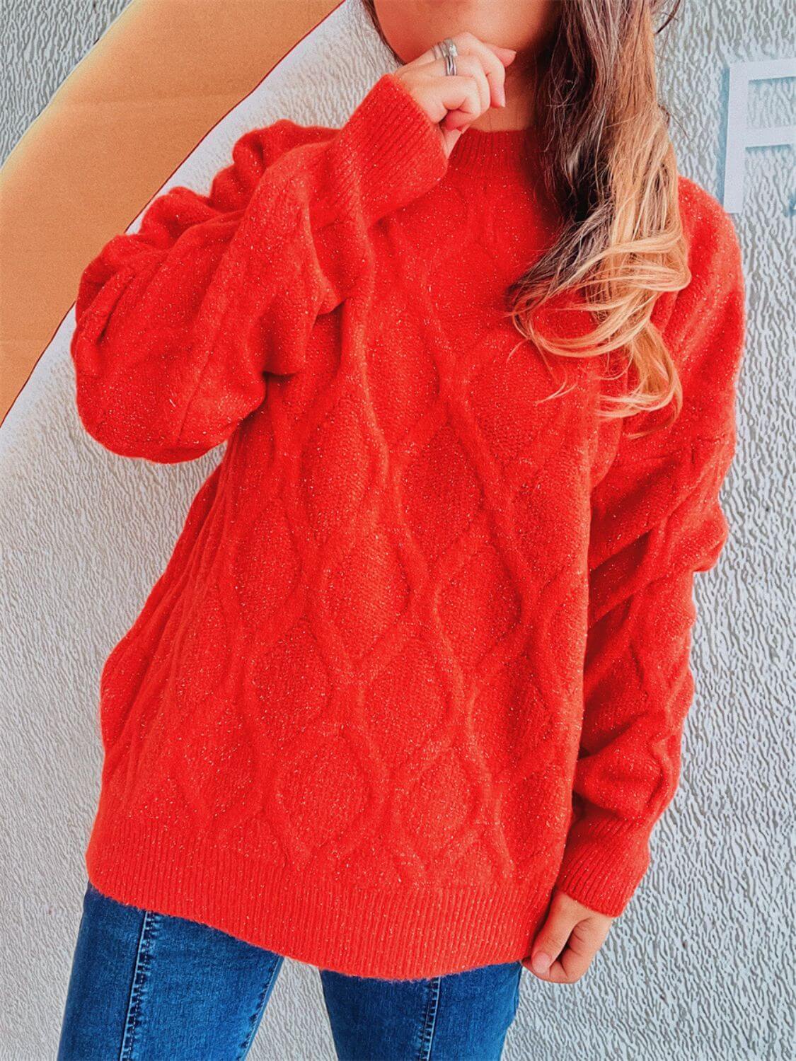 Woman wearing Bella Road Diamond Round Neck Long Sleeve Sweater in bright red, showcasing unique diamond pattern and classic round neck design.