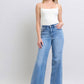 Woman wearing Judy Blue Full Size Wide Leg Jeans with Pockets, styled in a trendy outfit for a chic look.