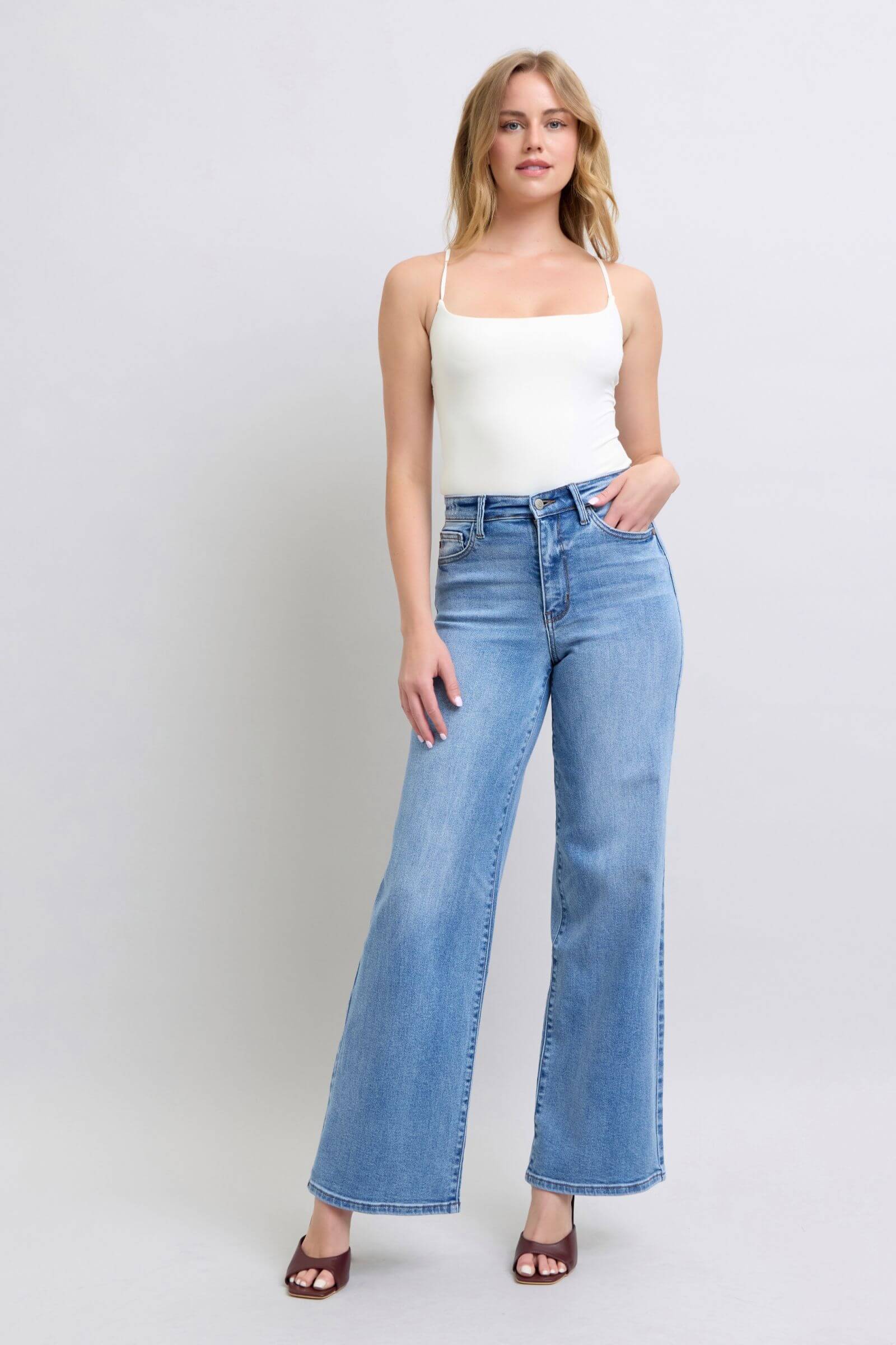 Woman wearing Judy Blue Full Size Wide Leg Jeans with Pockets, styled in a trendy outfit for a chic look.