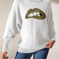 Woman wearing Bella Road Lip Turtleneck Long Sleeve Sweater with leopard print lip design, paired with jeans.