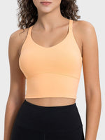 Millennia Crisscross Round Neck Active Tank in peach, featuring a fitted design and moderate stretch for optimal comfort.