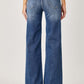 Woman wearing High Rise Frayed Hem Wide Leg Jeans from Risen Jeans, showcasing retro style with a flattering fit and trendy frayed hem.