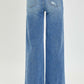 Back view of Risen Jeans high rise frayed hem wide leg jeans in blue denim, showcasing trendy vintage charm and edgy details.