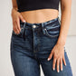 Woman wearing high waist raw hem jeans with tummy control and distressed detailing, showcasing a flattering and supportive fit. RFM Jeans.