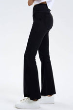 Side view of Basic Bae Pocketed Highly Stretchy Bootcut Jeans in black, showcasing a stylish fit and comfortable design.