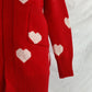 Close-up of Bella Road Heart Open Front Long Sleeve Cardigan in red with white heart patterns and pocket detail.