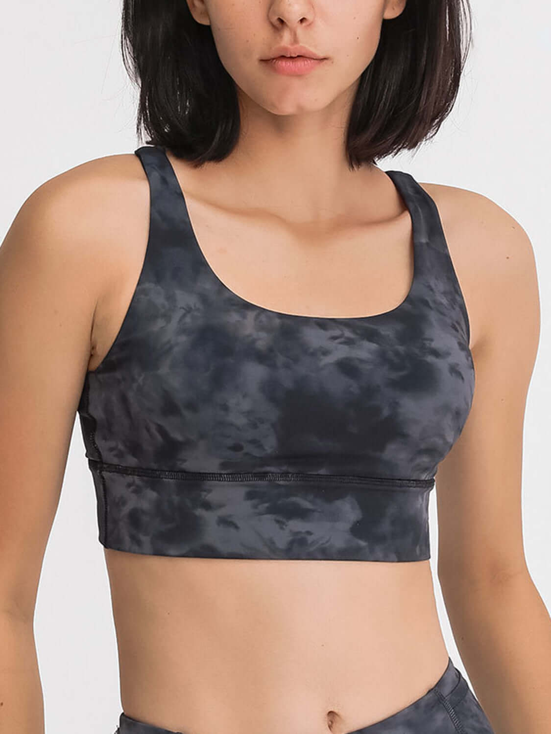 Stylish Millennia crisscross scoop neck tank in dark tie-dye, perfect for workouts with comfort and breathability.