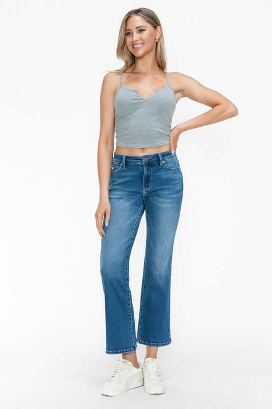 Model wearing bytos Cat's Whiskers Mid Rise Ankle Jeans with a gray crop top, showcasing a trendy and chic outfit.