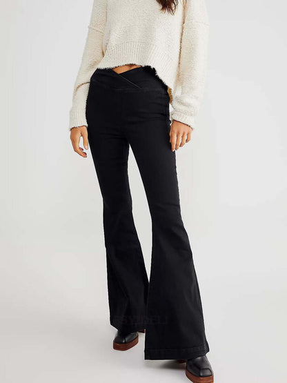 Woman wearing Asymmetric Waist Flare Jeans with a white sweater