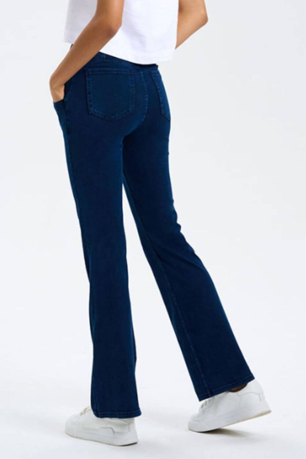 Model showcasing navy blue Basic Bae pocketed bootcut jeans with a stretchy fit, ideal for comfort and style.