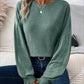 Woman wearing Bella Road Ribbed Round Neck Lantern Sleeve T-Shirt in green with casual jeans and accessorized with necklace and rings