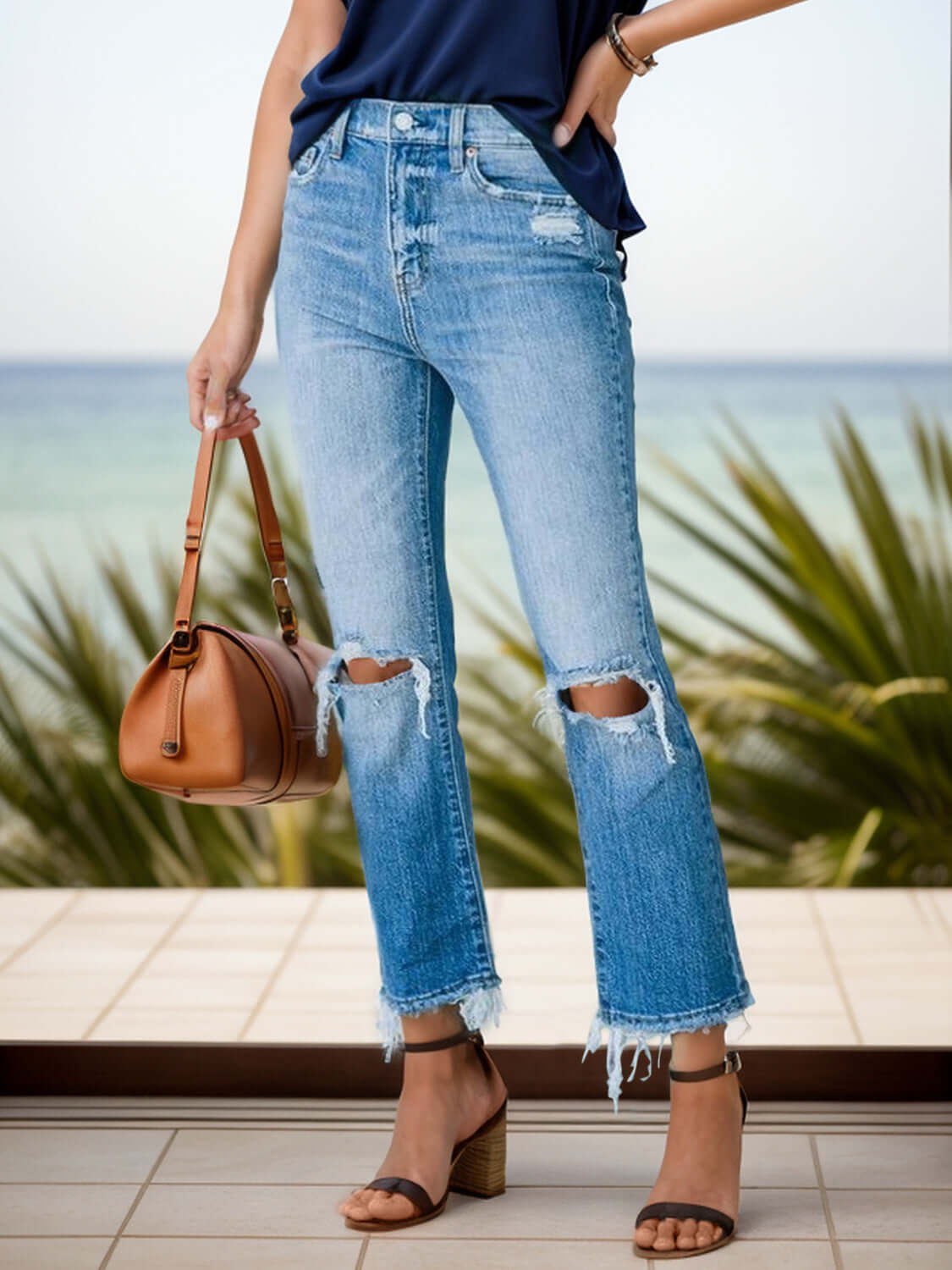 Distressed raw hem jeans with pockets, slightly stretchy, perfect for casual or edgy outfits, shown with handbag and sandals.