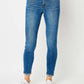 Woman wearing cuffed hem low waist Judy Blue skinny jeans in full size.