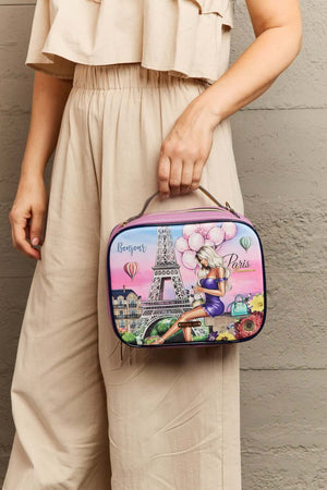 Woman holding Nicole Lee USA printed handbag with Parisian design and Eiffel Tower illustration