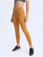 Model wearing Millennia Wide Waistband Leggings in tangerine, showcasing style and comfort with pockets for essentials.