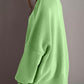 Woman wearing Double Take Side Slit Round Neck Long Sleeve Sweater in green, showcasing side slit and cozy design.