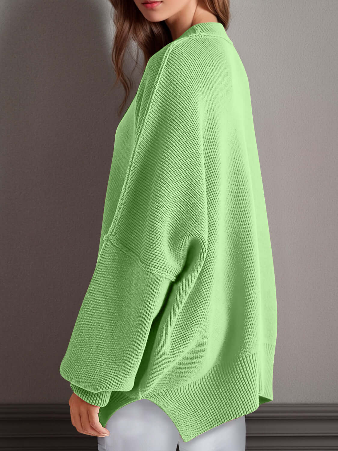 Woman wearing Double Take Side Slit Round Neck Long Sleeve Sweater in green, showcasing side slit and cozy design.