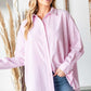 Woman wearing First Love Full Size Striped Button Down High-Low Hem Shirt in pink and white stripes with jeans.